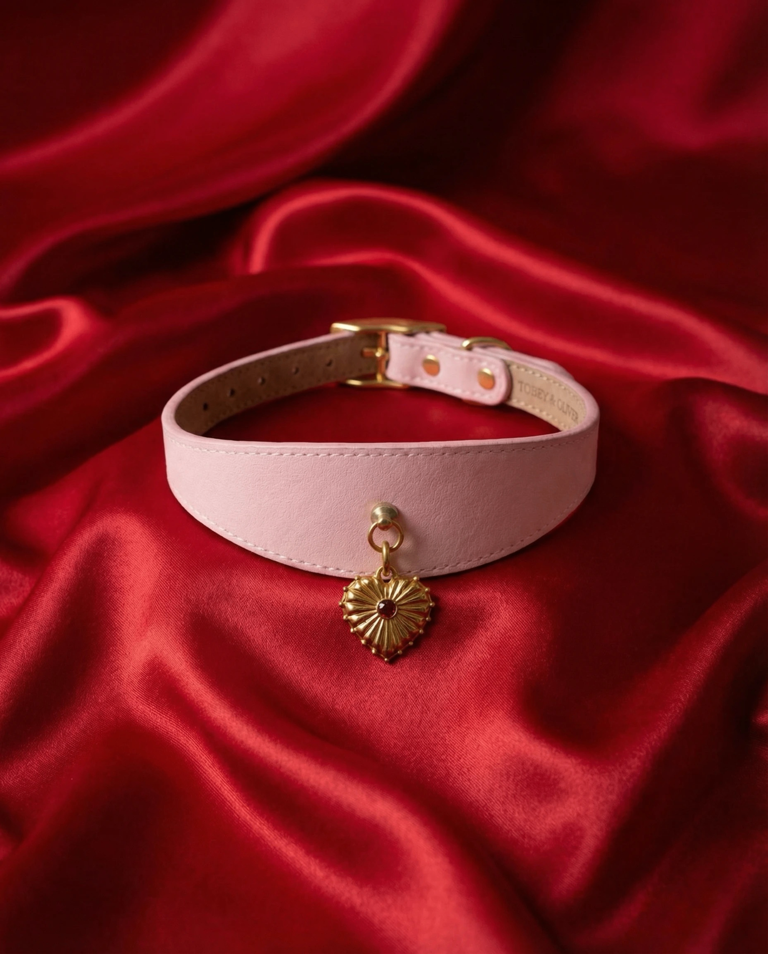 Tobey & Oliver cream leather collar with a gold heart charm on red silk